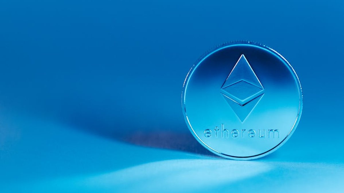 A minimalist image of an Ethereum coin on a blue background, highlighting modern finance.