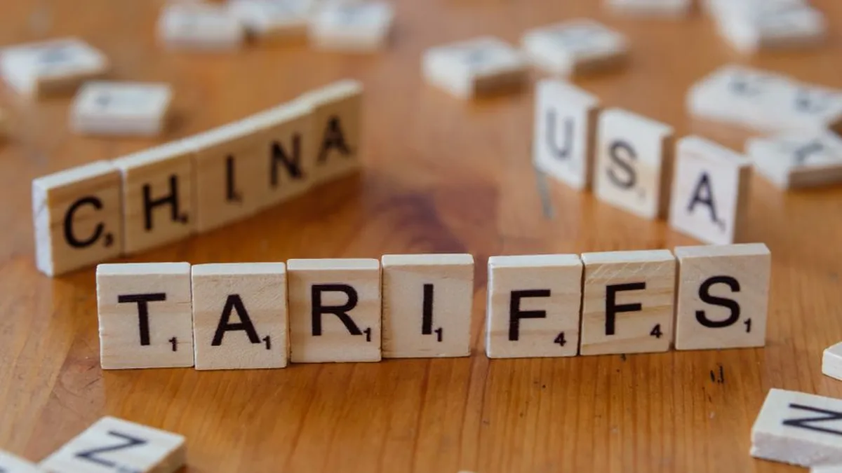 Wooden letter blocks spelling tariffs, China, and USA representing trade relations.